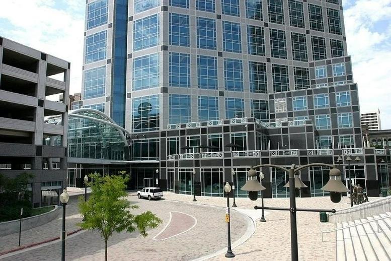Exterior view of the glass-facade Wells Fargo Center showing the main entrance and plaza.