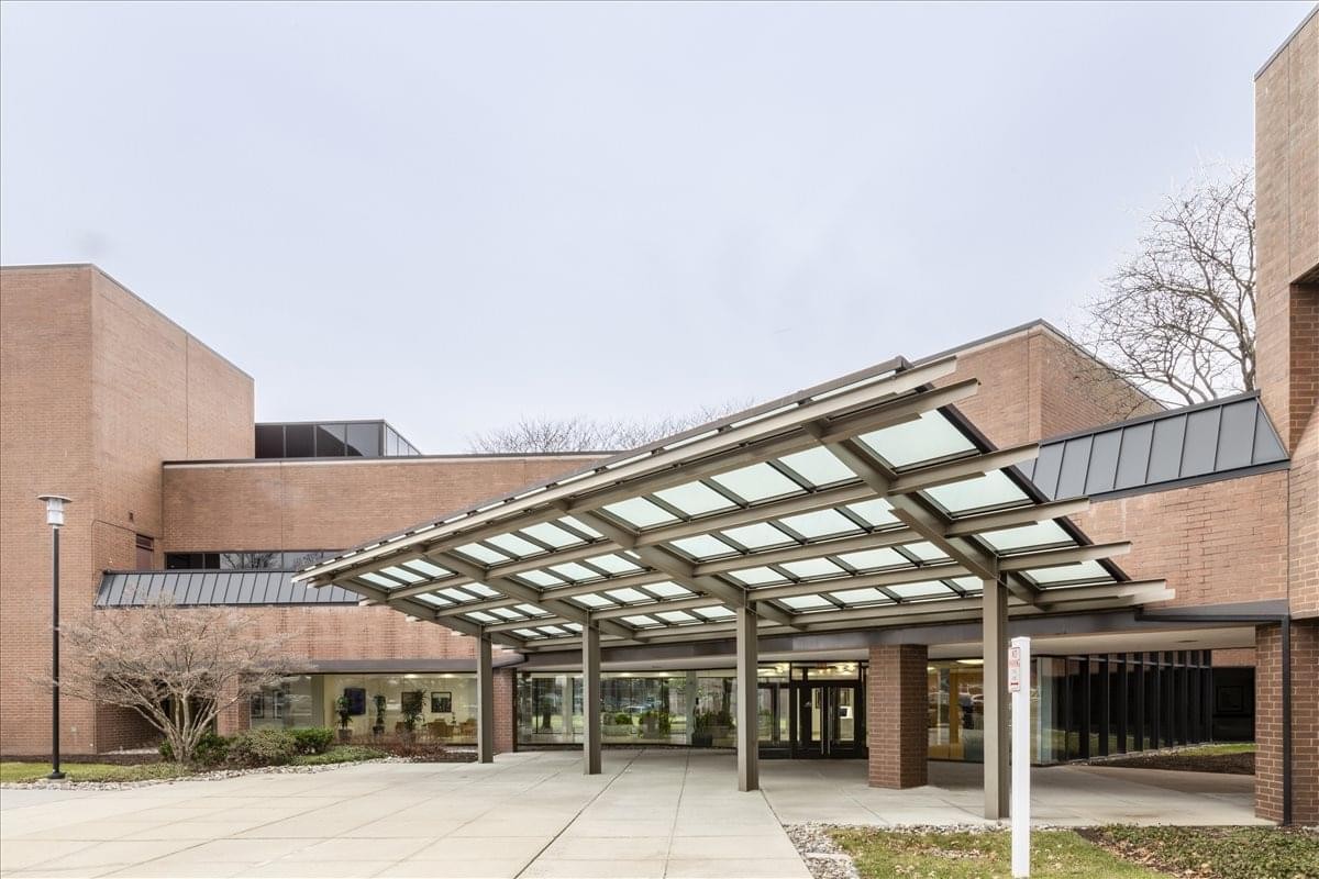 Modern brick exterior and glass canopy entrance at 30 Knightsbridge Road.