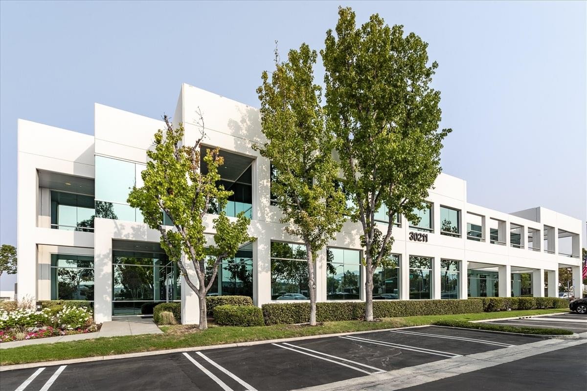 Exterior view of the modern white office building at 30211 Avenida de las Banderas.