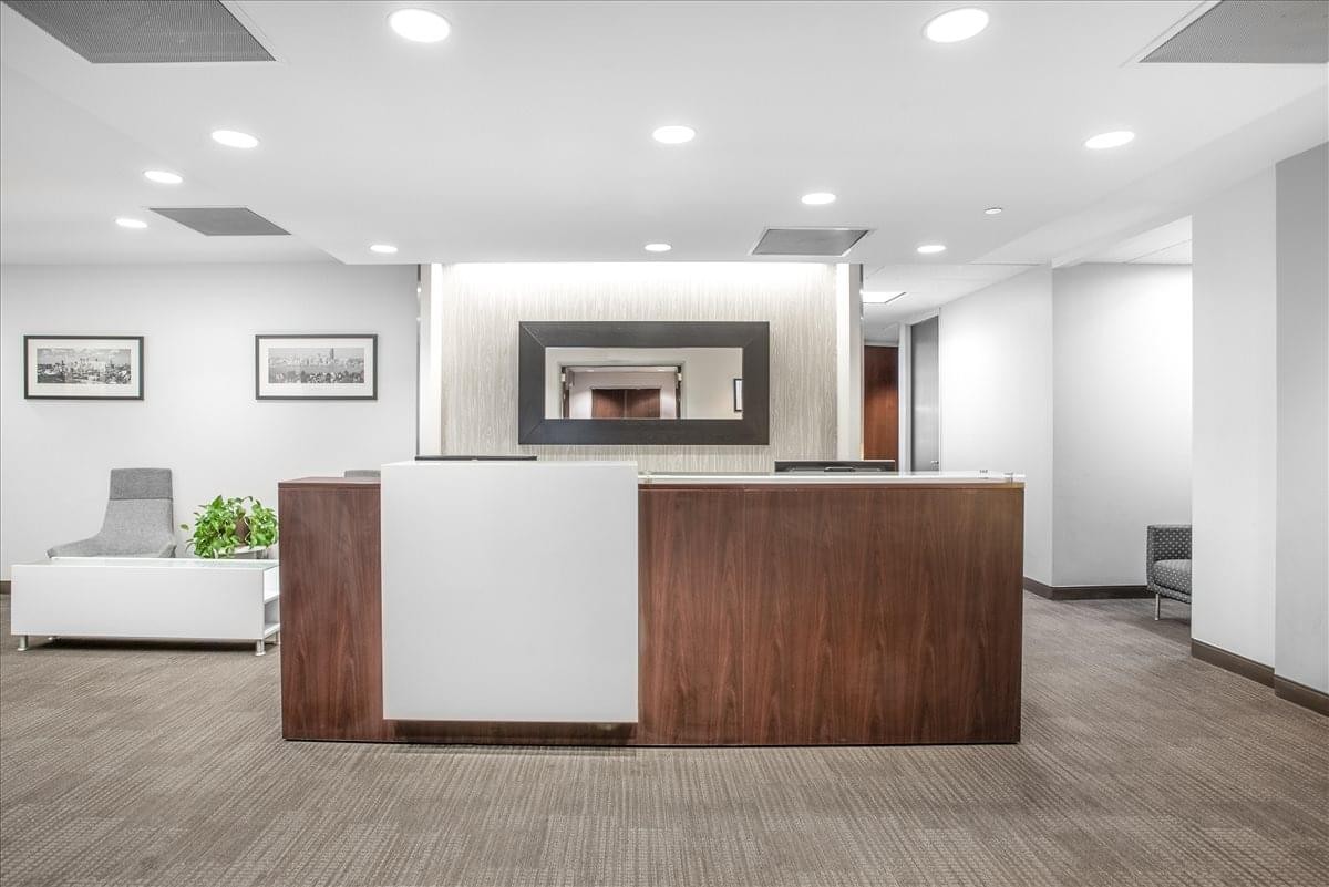 Modern reception desk with wood and white panels at 303 Twin Dolphin Drive, Redwood Shores, Suite 600.