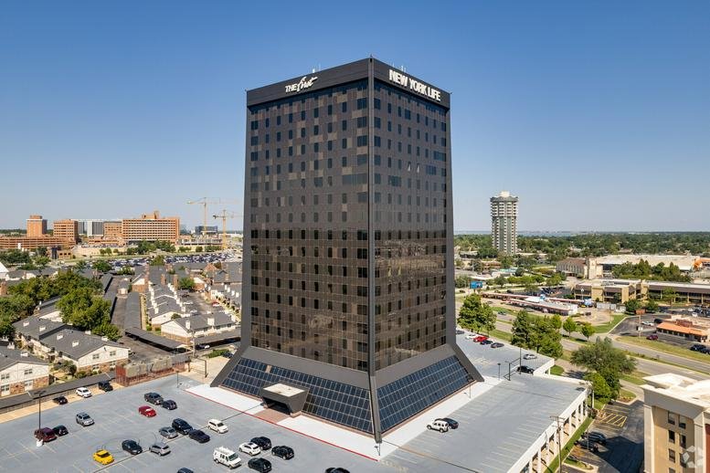 Exterior view of the dark-facade Union Plaza building and surrounding parking lot.
