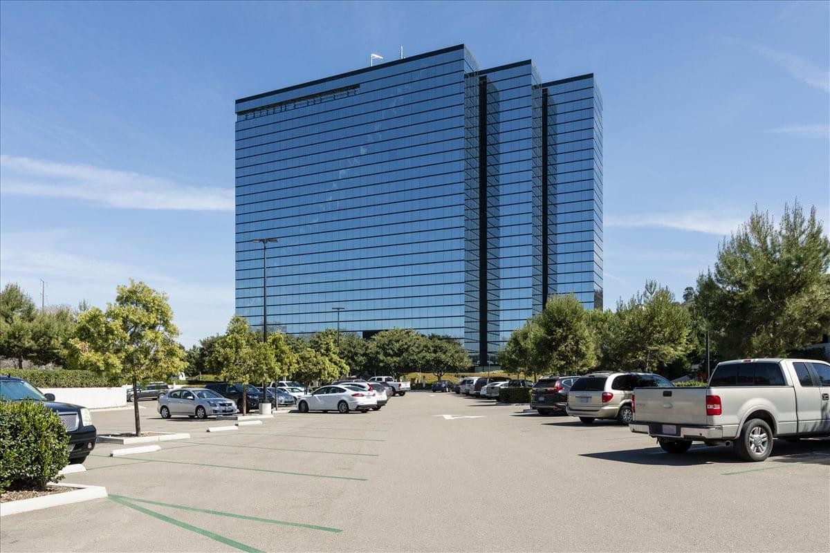 Exterior view of the blue glass skyscraper at 3111 Camino Del Rio North.