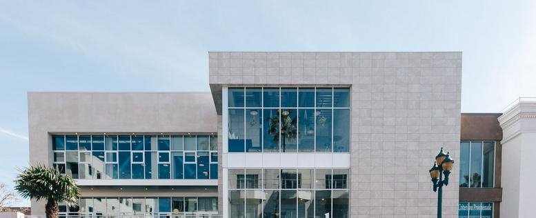 Exterior facade of the modern glass and stone building at 312 Arizona Avenue, Promenade.