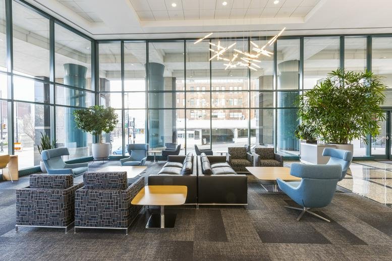 Expansive communal lounge with diverse seating options and floor-to-ceiling glass walls.