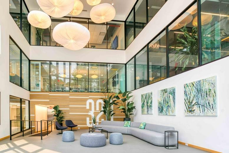 Grand multi-story lobby at HAYVN, 320 Boston Post Road, Darien, Connecticut with hanging globe lights.