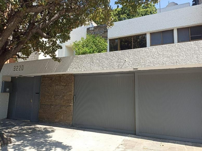 Exterior view of the white facade and gated entrance of Antonio Valeriano Business Center.