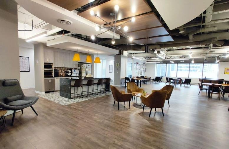 Spacious communal lounge at 324 8 Avenue Southwest, 12th Floor, Downtown, Calgary with warm wood floors.