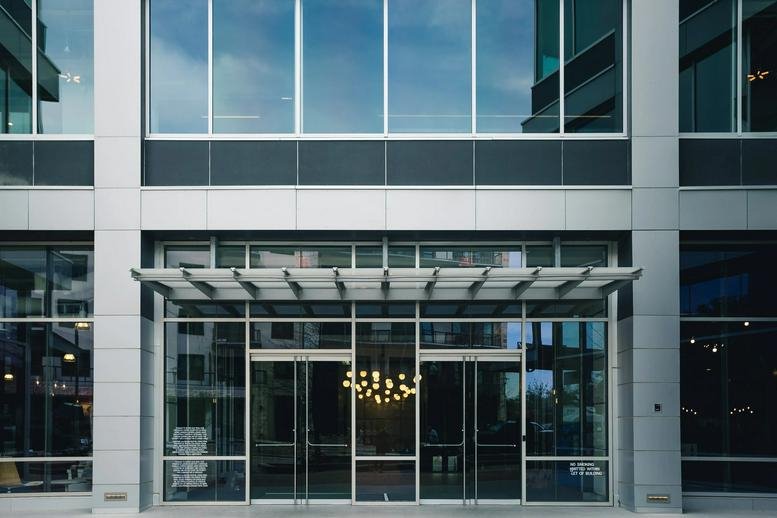 Modern glass and steel exterior facade of the building at 3300 North Interstate Hwy 35.