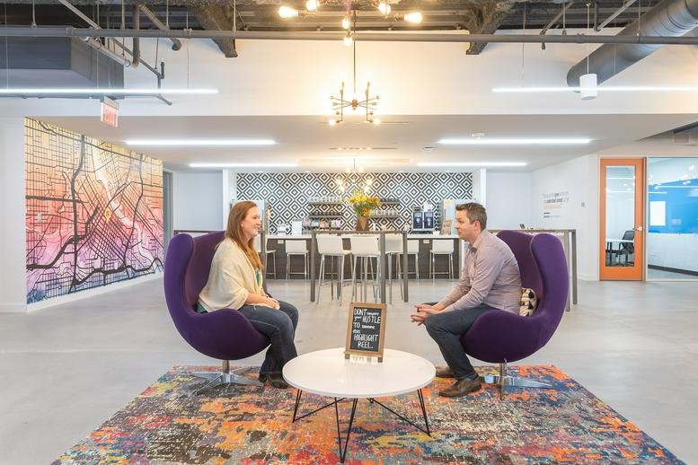 Spacious communal lounge at 331 2nd Ave S with purple egg chairs and vibrant feature wall art.
