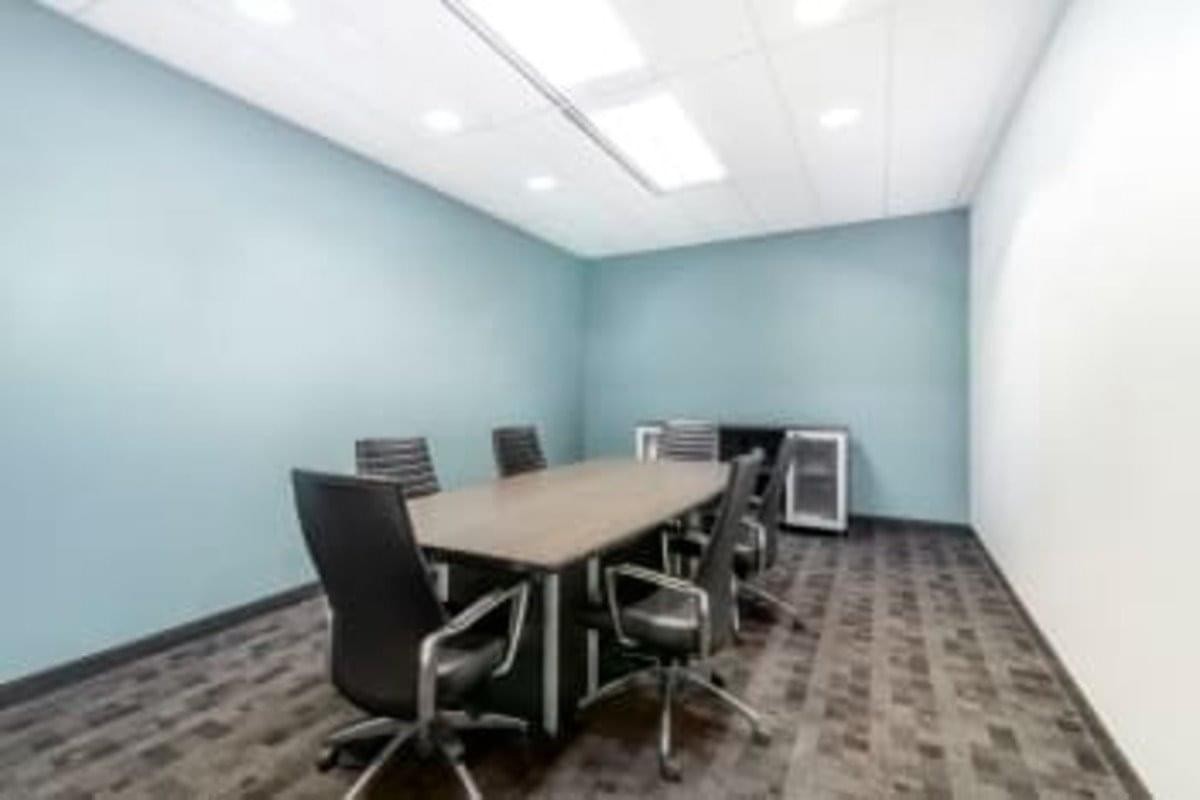 Spacious boardroom at 343 Preston Street with a large wooden table and blue accent walls.
