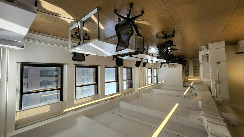 Modern open workspace at 345 7th Avenue featuring rows of desks and polished floors.