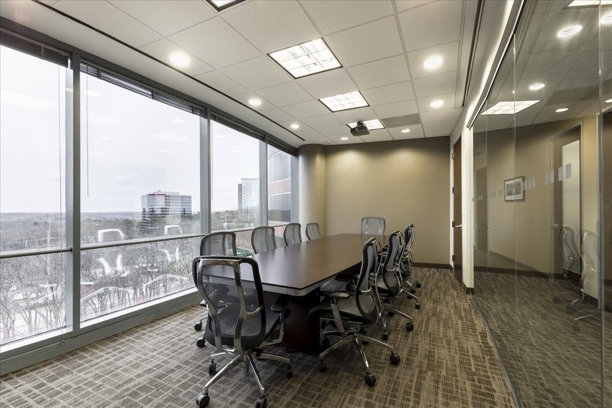 Spacious boardroom at 3500 Lenox Rd with city views and glass walls.