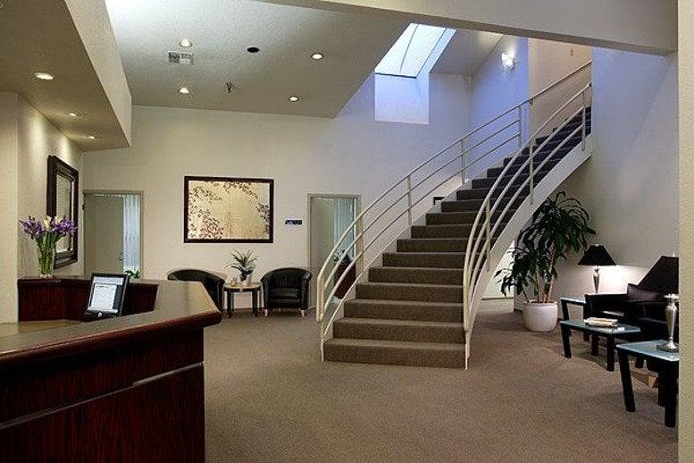 Spacious reception area at 3550 Watt Avenue, Suite 140 with a grand staircase and skylight.