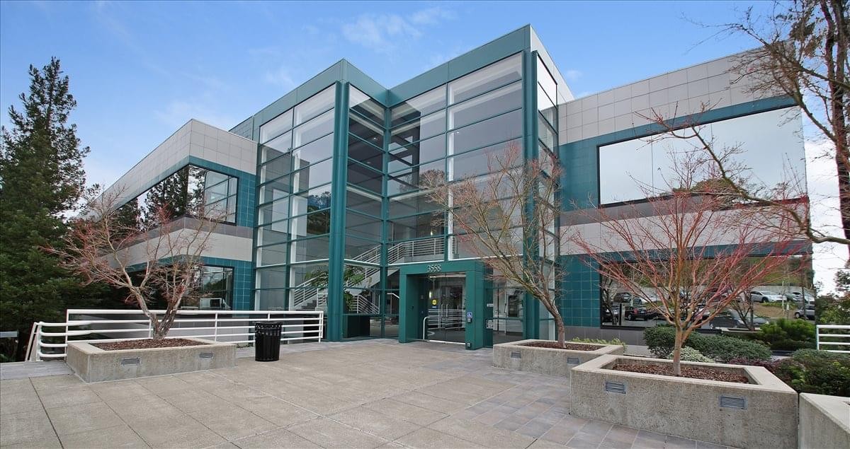 Exterior view of the glass-facade 3558 Round Barn Blvd building.