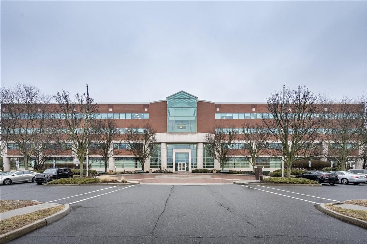 Exterior view of the brick and glass office building at 3600 Route 66, Suite 100.