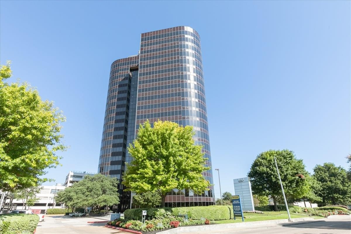 Exterior view of the multi-story glass office building at 363 N Sam Houston Pkwy E.