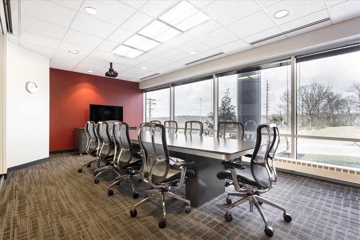 Spacious boardroom at 3636 S. Geyer Road, Suite 100 with large windows and red feature wall.