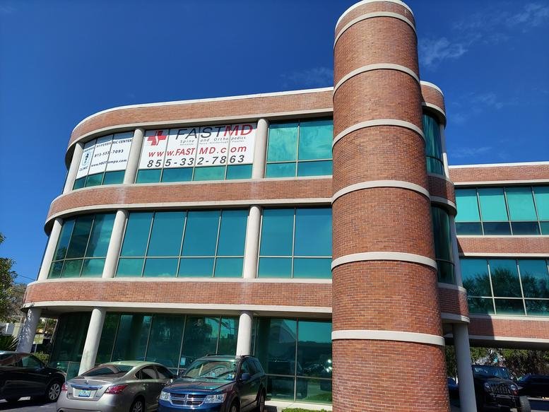 Exterior view of the brick and glass office building at 3902 Henderson Boulevard.