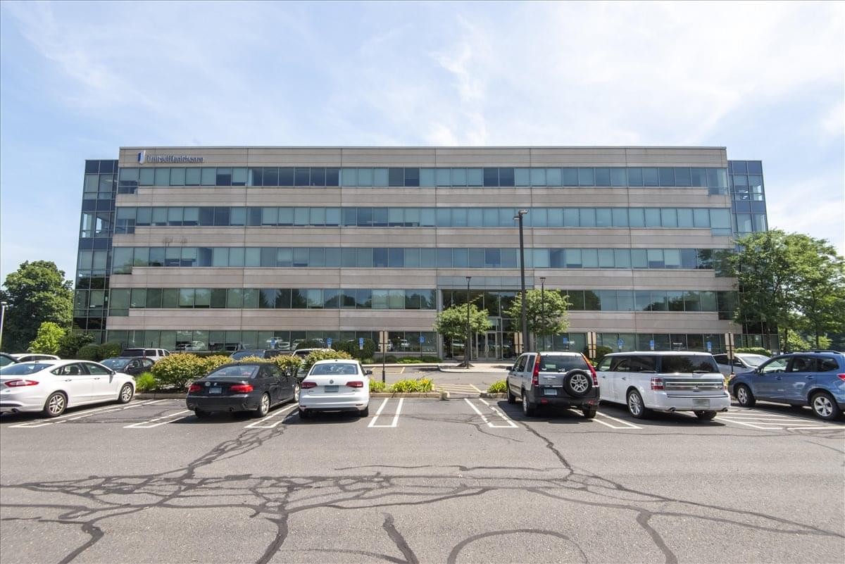 Exterior view of the multi-story Reservoir Corporate Center building with surface parking.