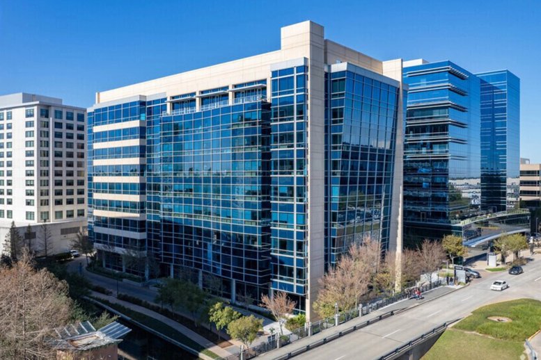 Modern glass-facade exterior of 4 Waterway Square Place in The Woodlands.