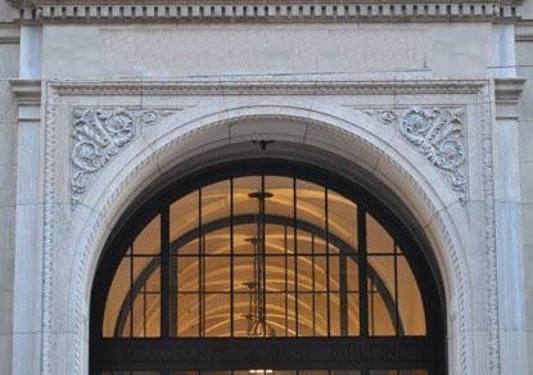 Ornate stone archway at the main entrance of 40 Worth Street, New York.