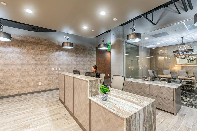 Reception area at 400 North Ashley Drive with a patterned wall and modern pendant lighting.
