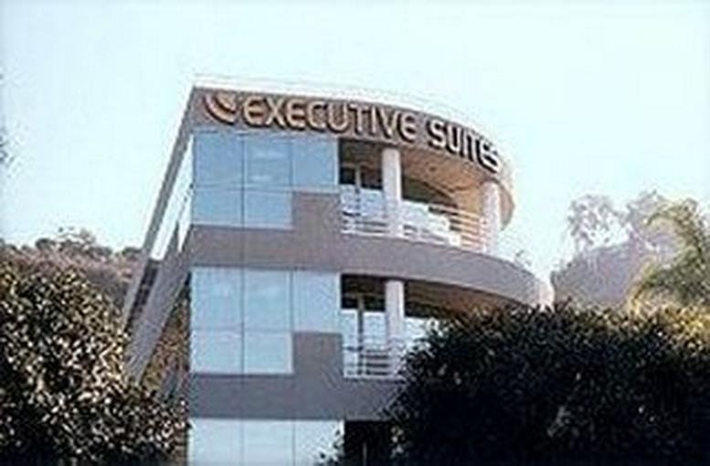 Exterior view of the modern curved glass facade at Mission Valley Offices.