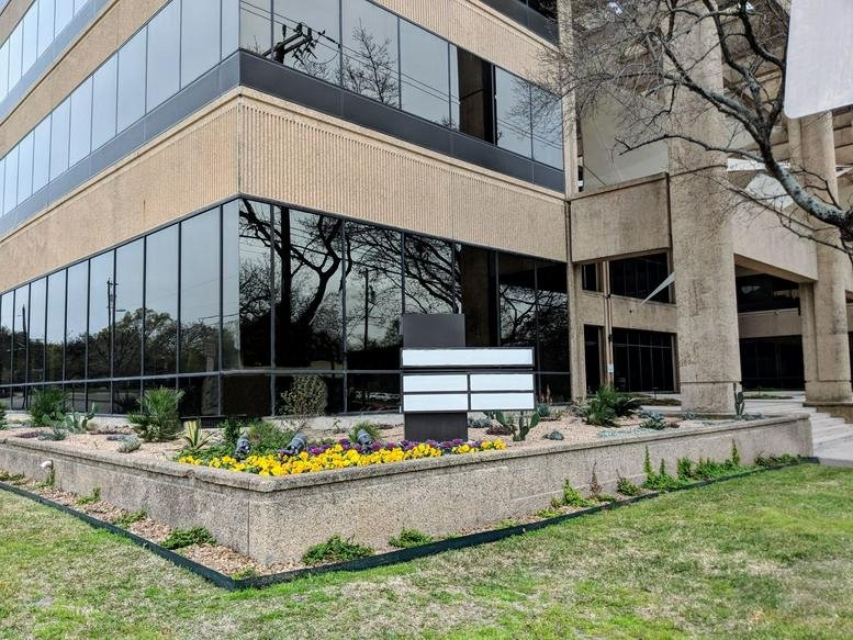 Exterior facade and landscaped entrance at 4040 Broadway St, Suite 240.