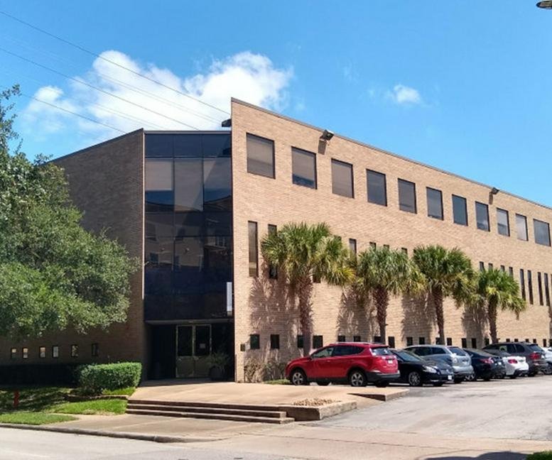 Exterior view of the brick facade and palm trees at 4101 McEwen.