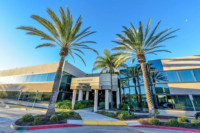 Exterior view of the palm-lined modern office building at 41593 Winchester Road.