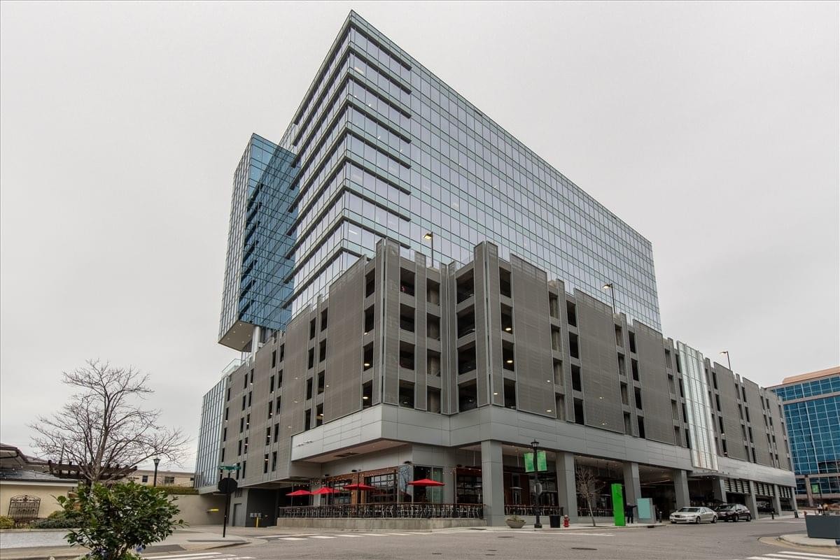 Exterior view of the North Hills Tower II at 4242 Six Forks Road showing the glass facade and tiered structure.