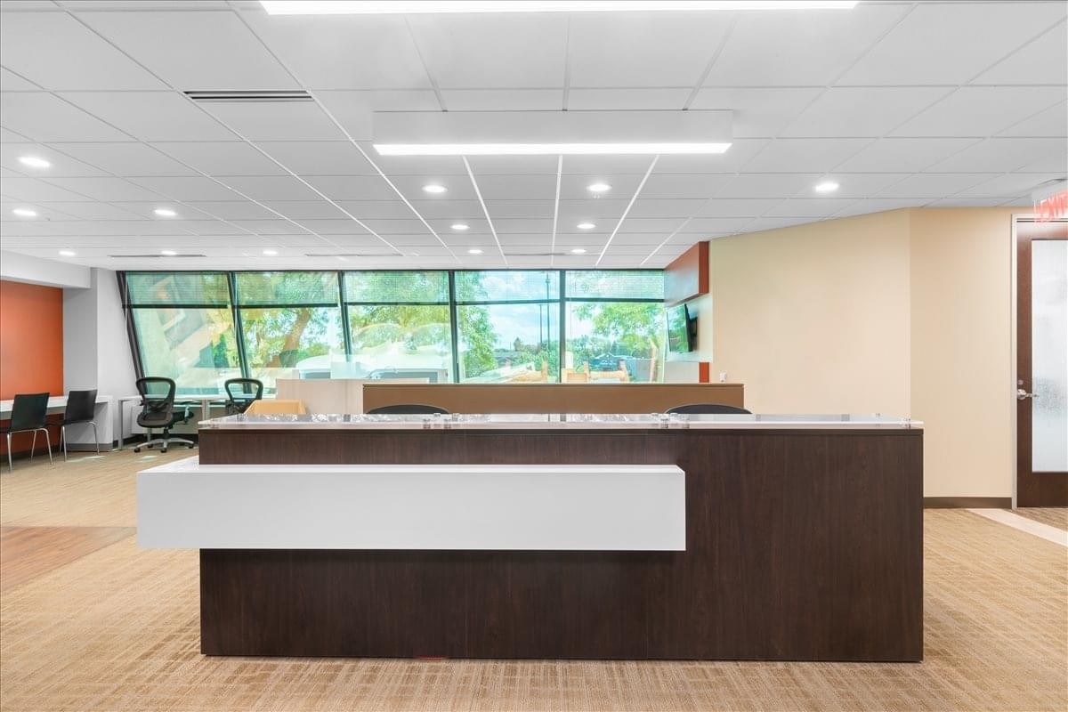 Reception desk at 4321 West College Avenue, Suite 200, Fox River Mall, with a dark wood and white finish.
