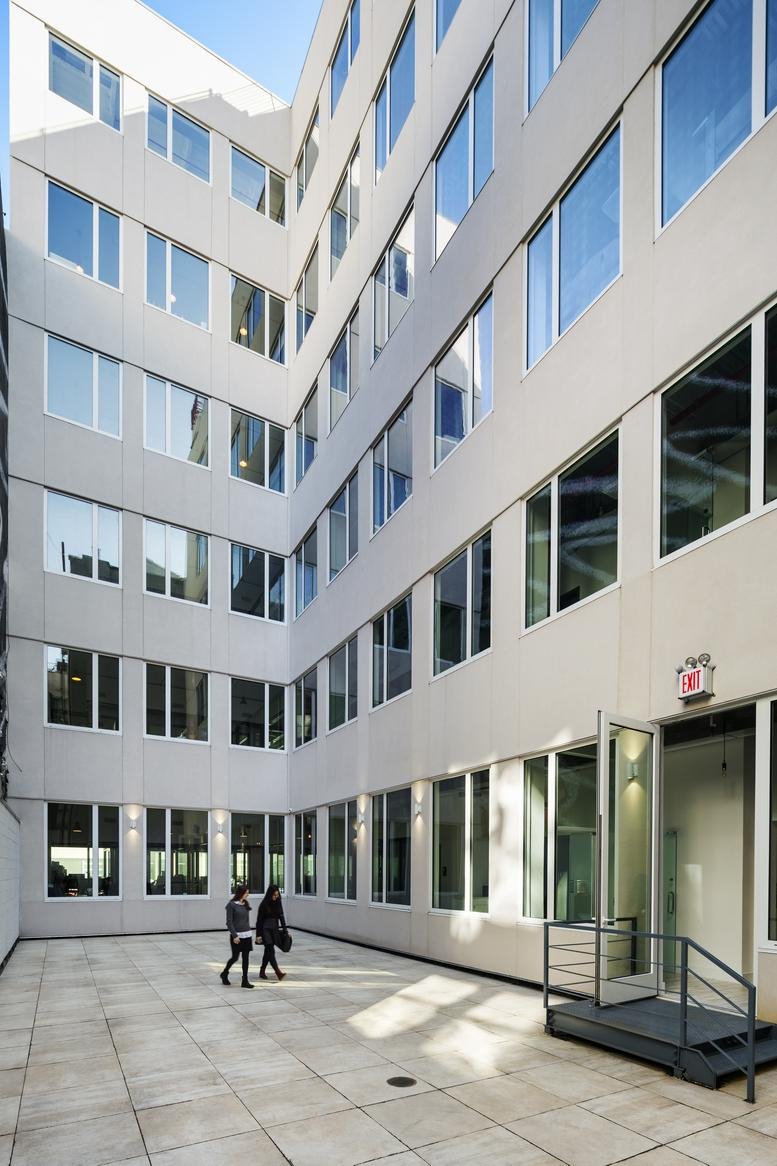 Exterior view of the modern white facade at Cubico, 433 Broadway.