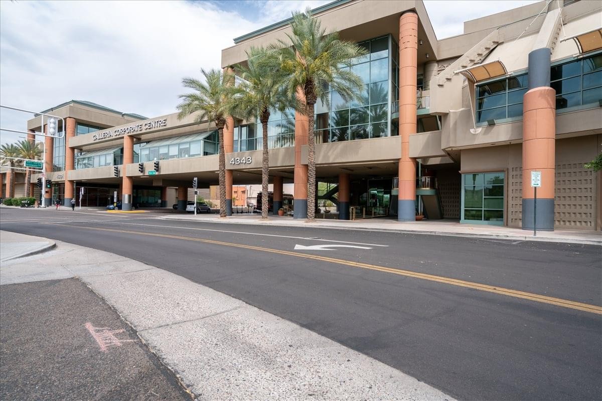 Exterior facade of the modern office building at 4343 N Scottsdale Rd with palm trees.