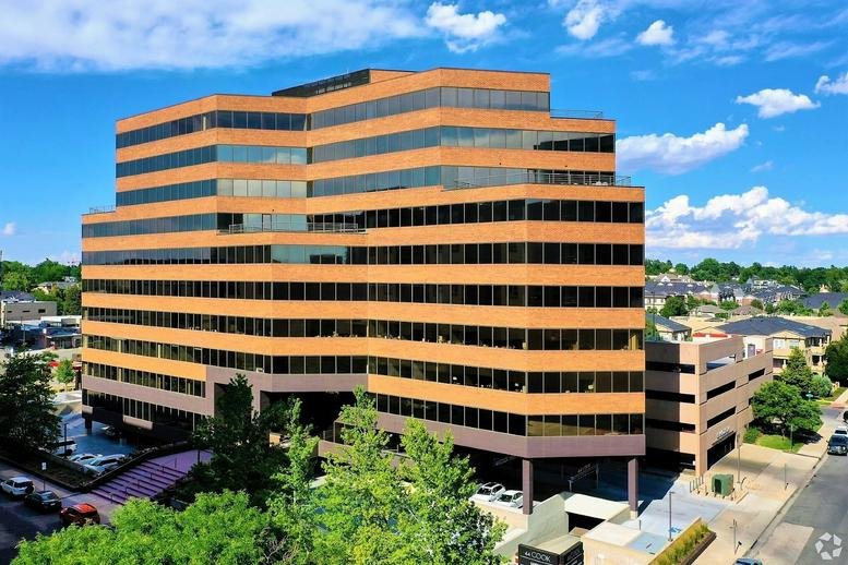 Exterior view of the multi-level brick and glass building at 44 Cook Street, Cherry Creek.