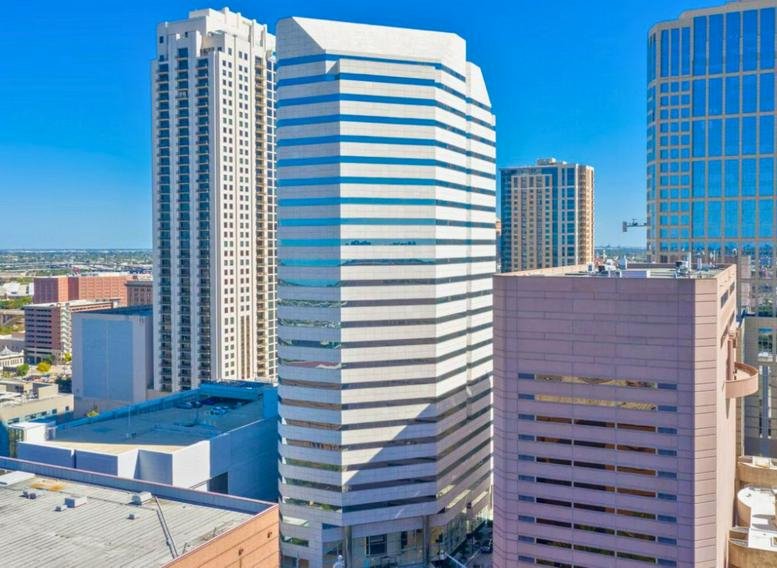 Wide exterior shot of the Lyric Tower facade set against a clear blue sky.