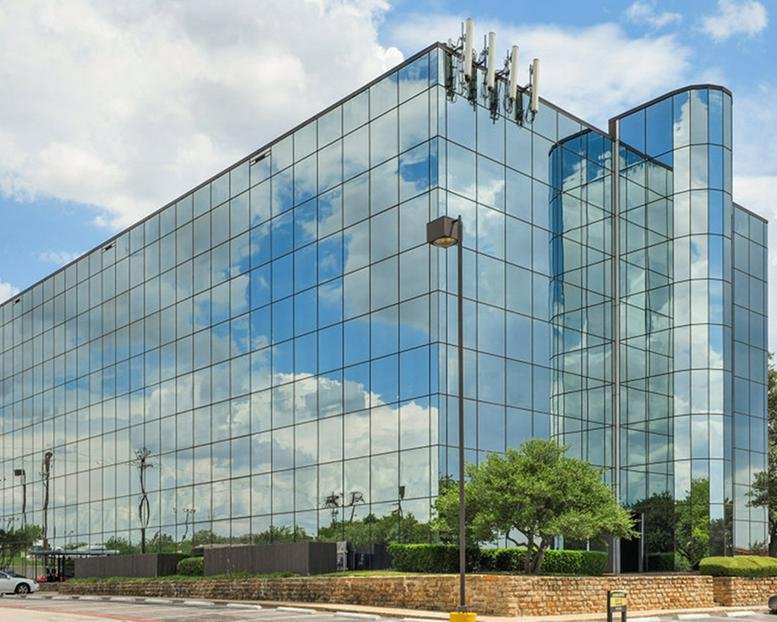 Exterior glass facade of the office building at 4425 W Airport Freeway.