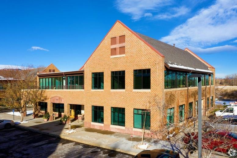 Exterior view of the brick facade and gabled roof at 4450 Arapahoe Avenue, Suite 100.