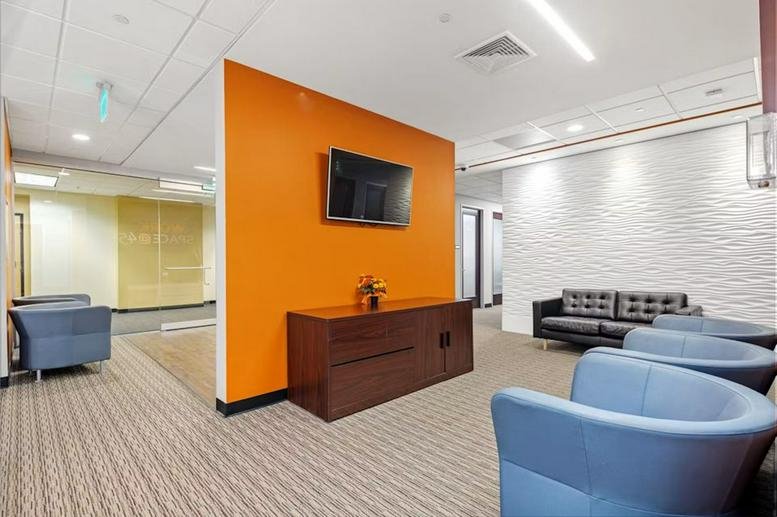Modern reception area at 45 Dan Road, Canton, MA with a blue feature wall and white desk.