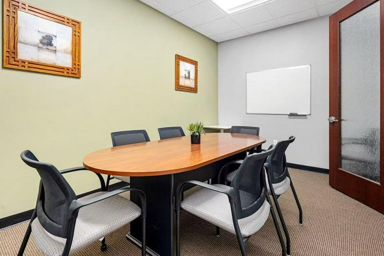 Spacious reception area for 45 Dan Road, Canton with a branded blue wall and sleek white desk.
