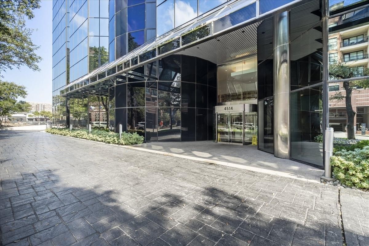 Exterior entrance of the modern glass-facade building at 4514 Cole Avenue.