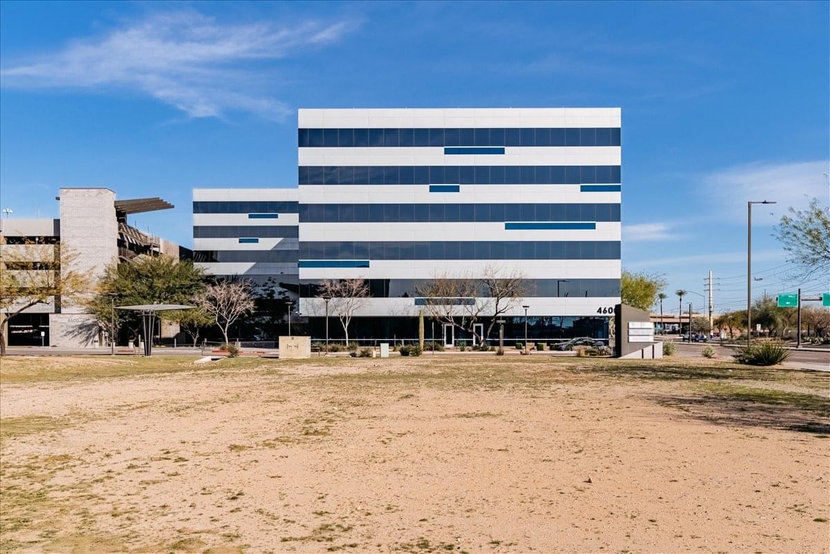 Exterior view of the modern glass-banded building at 4600 East Washington Street, Suite 300.