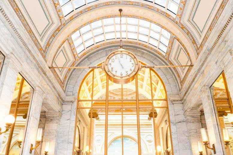 The ornate, vaulted marble lobby and grand clock at 465, California Street, 7th Floor, San Francisco.
