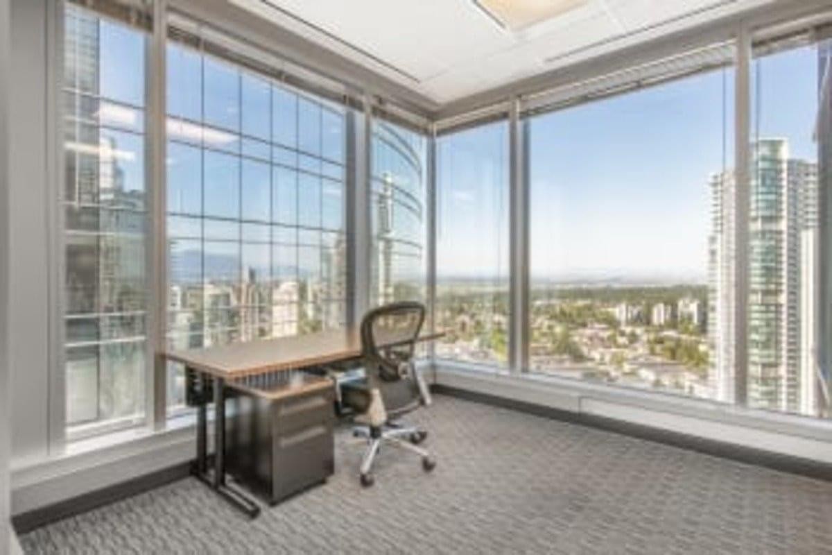 Corner office suite at 4720 Kingsway, Suite 2600 with floor-to-ceiling windows and panoramic city views.