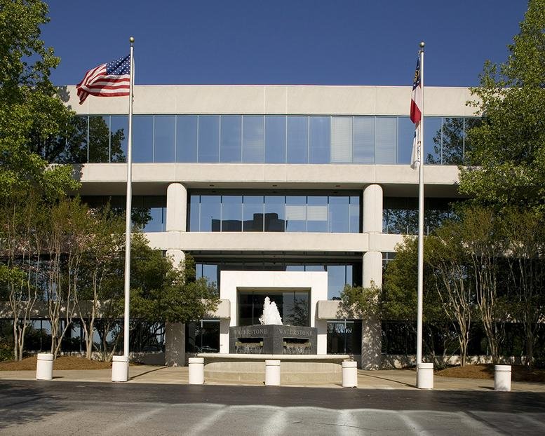 Exterior view of the white tiered office building at 4751 Best Road, College Park (GA).