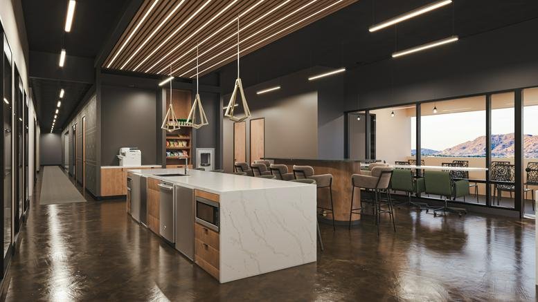 Modern communal kitchen at 4800 North Scottsdale Road, Suite 4500 with a large marble island and pendant lights.