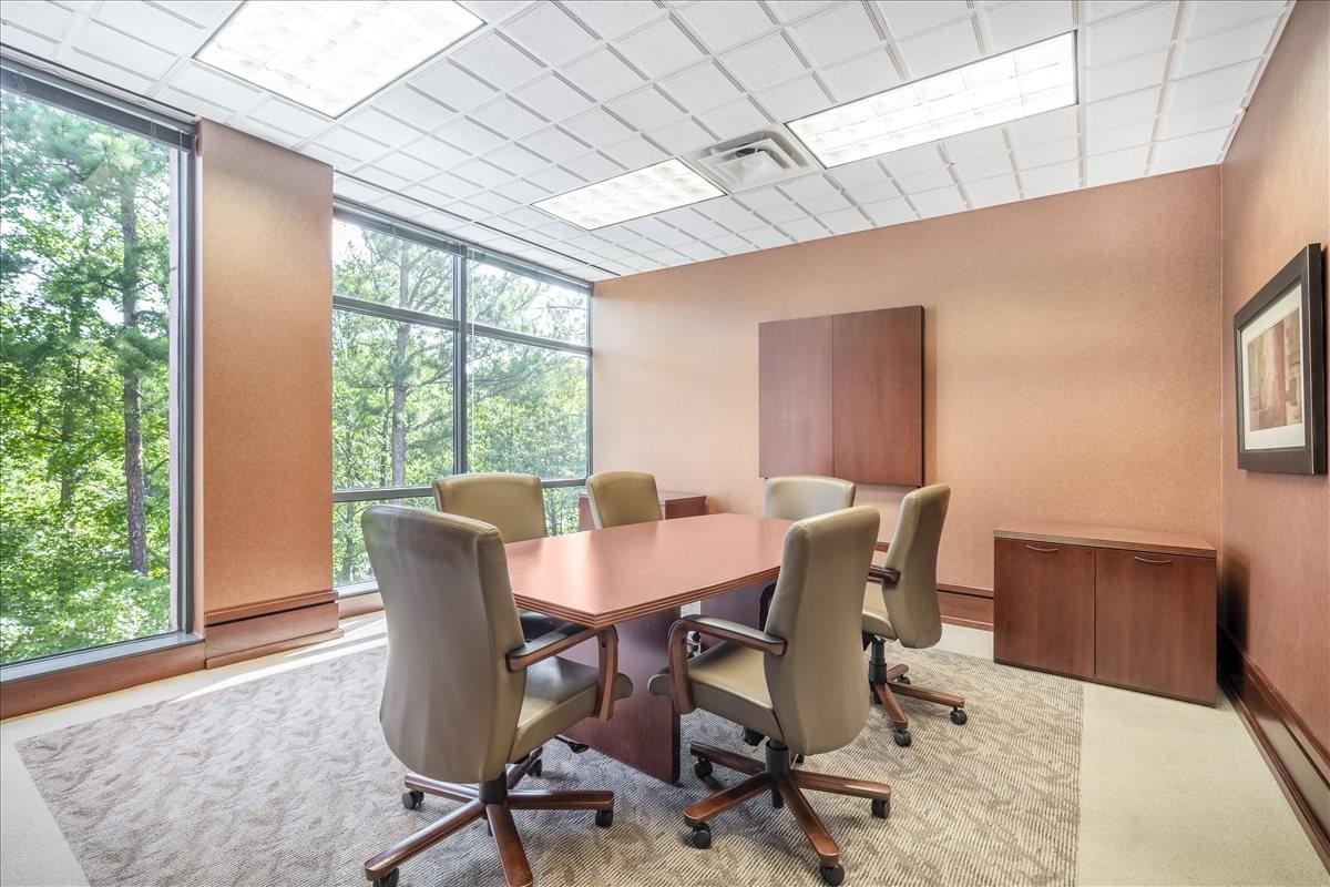 Professional boardroom at 4870 Sadler Road, Suite 300, featuring a large wooden table.