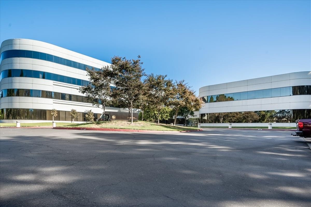 Exterior view of the modern, curved white facade at 4900 Hopyard Road, Suite 100, Pleasanton Center.
