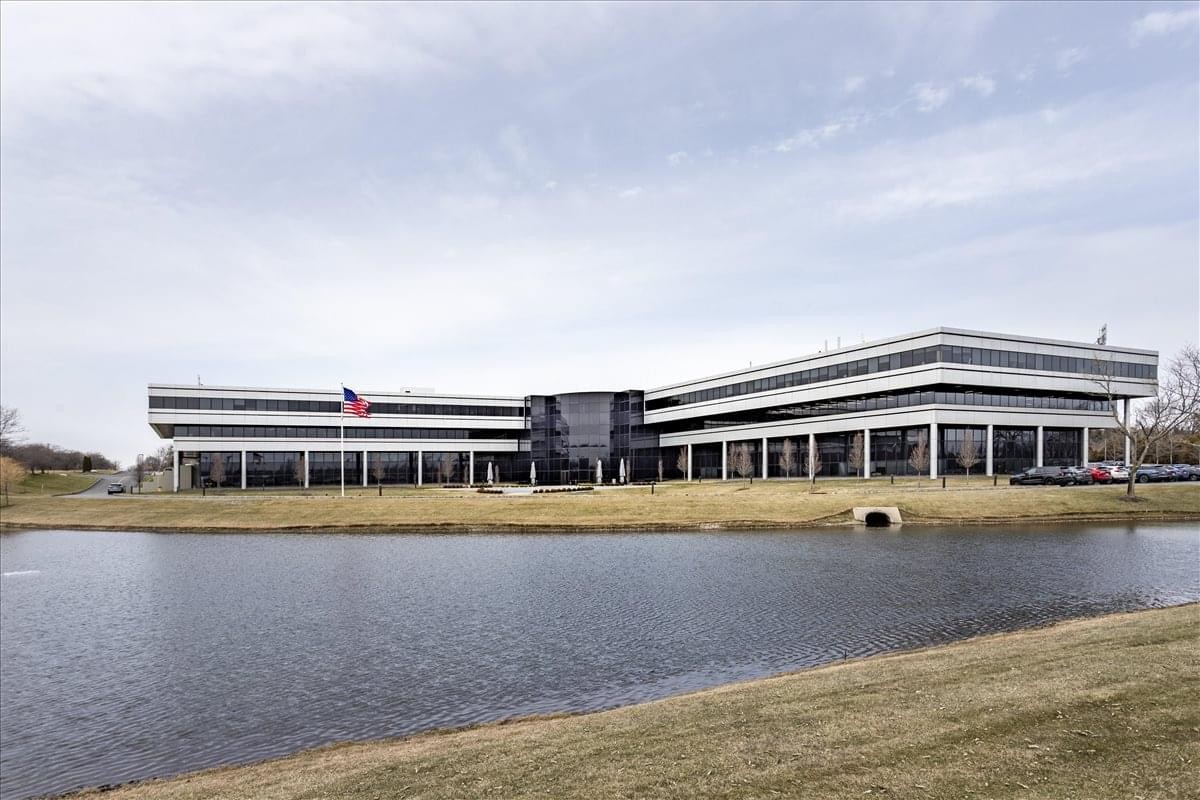 Exterior view of the low-rise office building with glass facade at 50 Tice Boulevard.