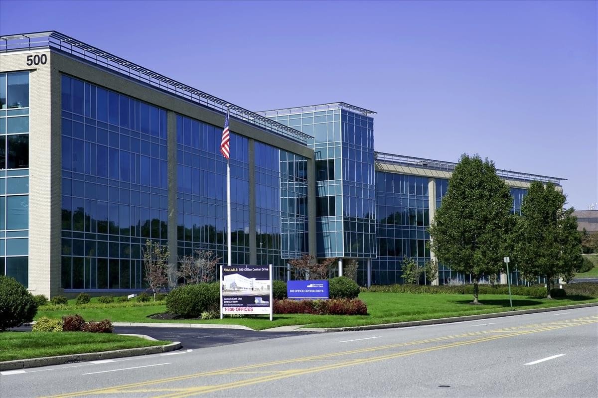 Exterior view of the glass and stone facade at 500 Office Center Drive.